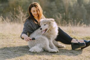 women playing with dog