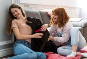 women playing with dog